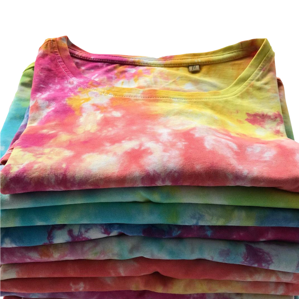 A pile of neatly folded tie dye t-shirts, each one unique and hand dyed on organic cotton t-shirts