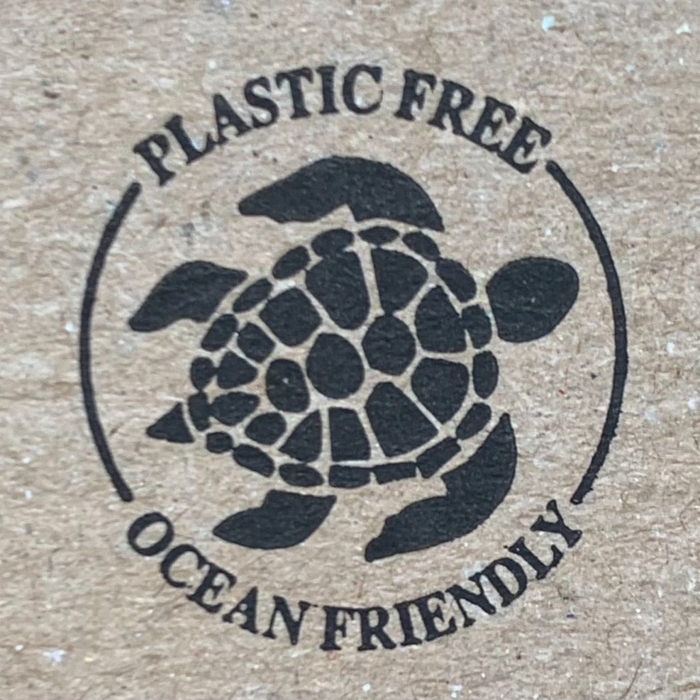a close up of a stamp on recyclable packaging that shows an image of a turtle and says "plastic free, ocean friendly"
