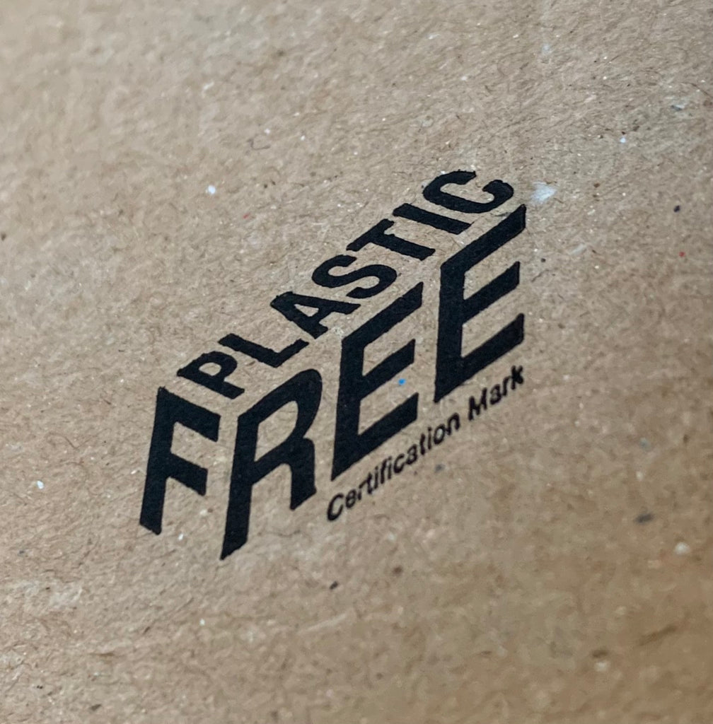 close up of a stamp on recyclable packaging with the words "plastic free certification mark"
