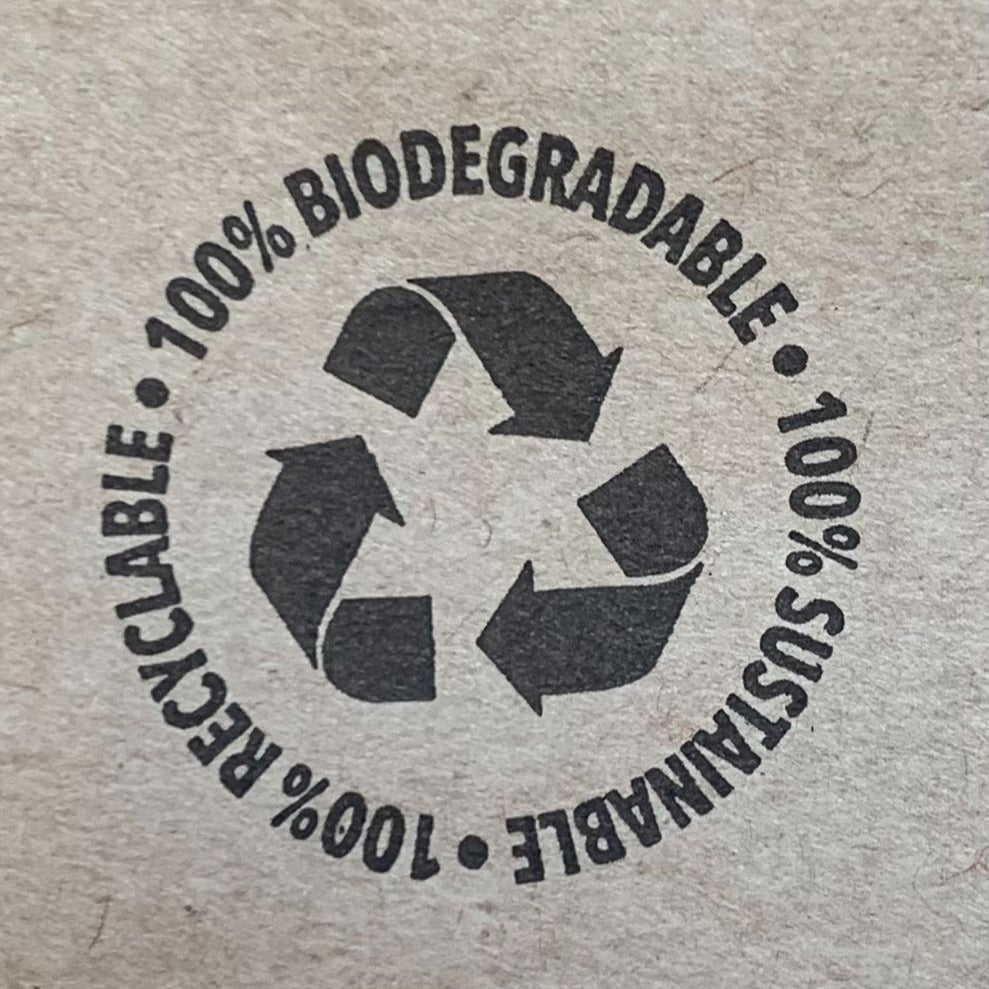 a close up of a stamp on recyclable packaging which shows the recycling symbol and the words "100% recyclable, 100% biodegradable, 100% sustainable"