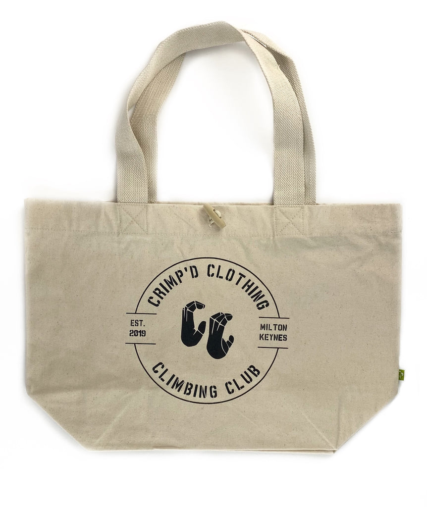 An organic cotton tote bag with 20 litre capacity, toggle fastening and club logo print on the front that says Crimp'd Clothing Climbing Club