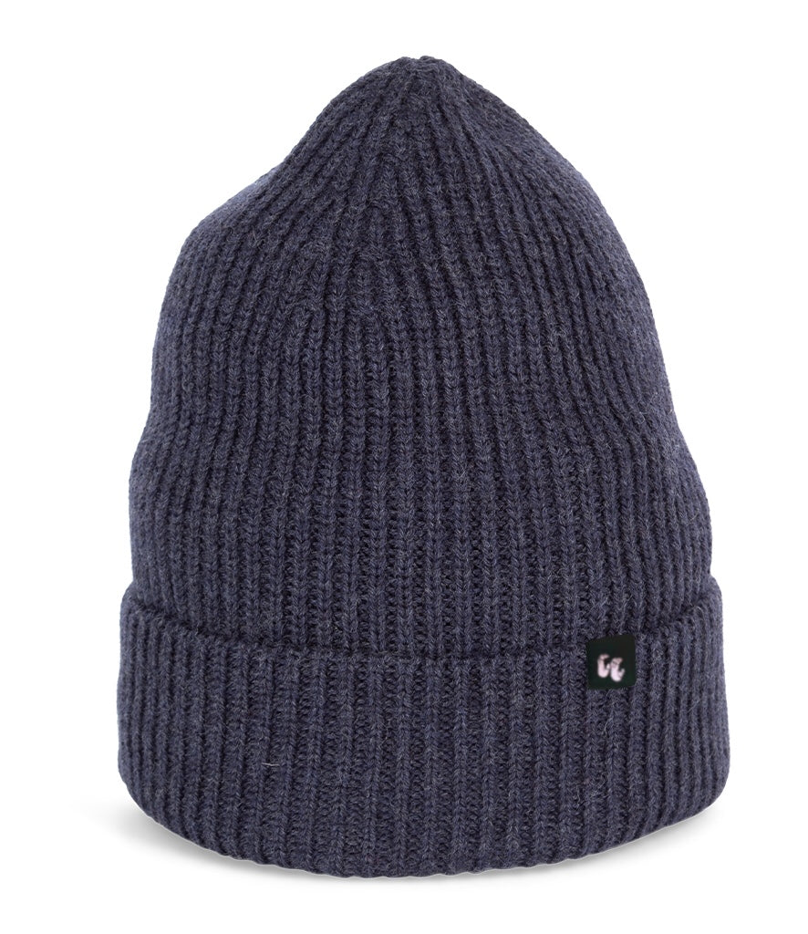 A dark, heather navy blue beanie with chunky, fisherman-style ribbed knit. It has a black fabric label with a white logo stitched to the cuff