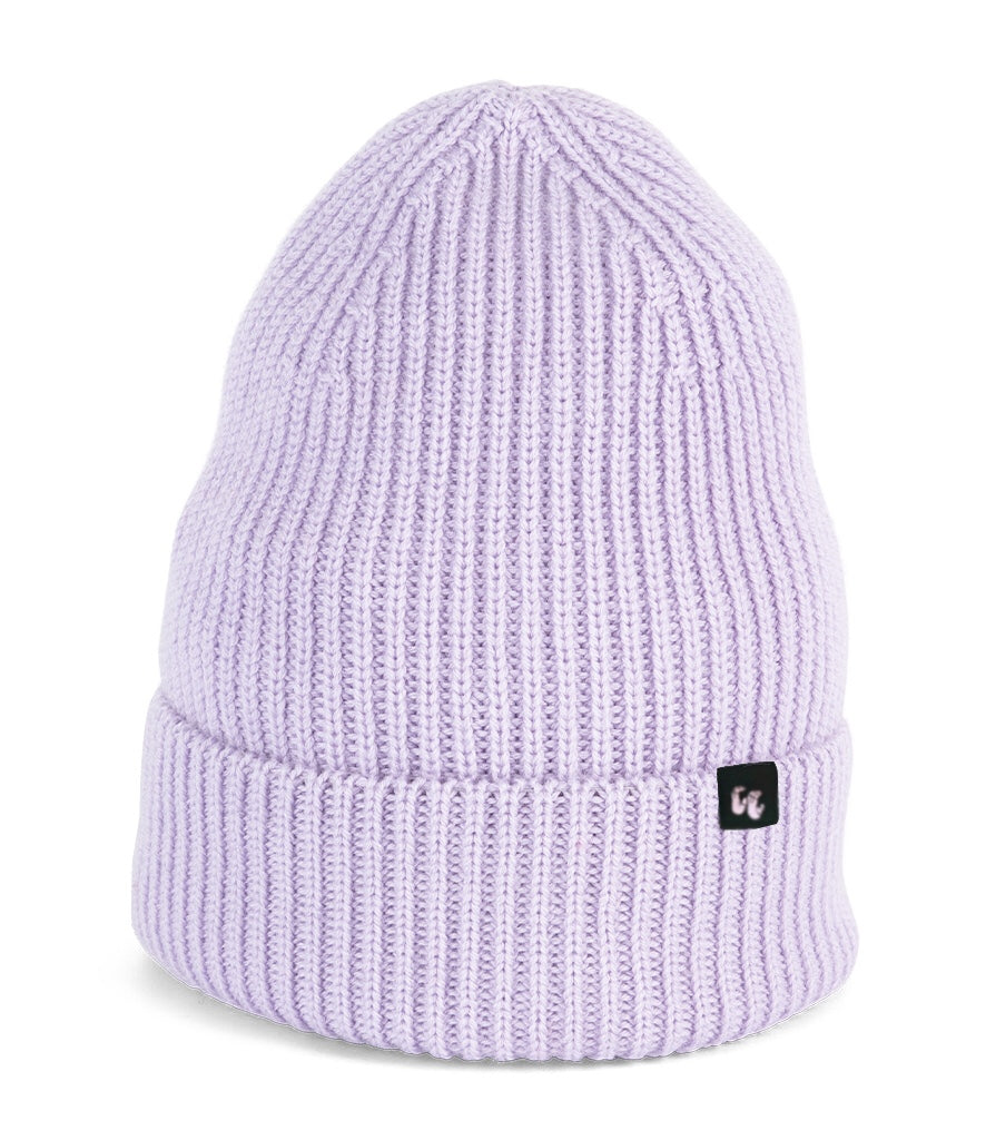 A beautiful pale lilac beanie with chunky, fisherman-style ribbed knit. It has a black fabric label with a white logo stitched to the cuff