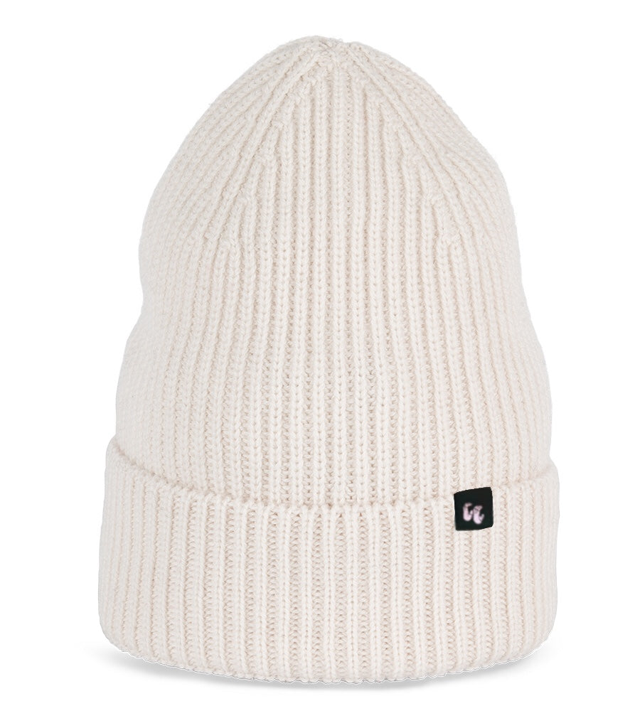 A very light ivory beanie with chunky, fisherman-style ribbed knit. It has a black fabric label with a white logo stitched to the cuff
