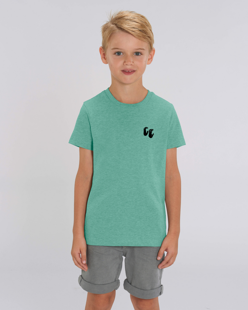 A boy wearing a kids organic cotton t-shirt in mid heather green, with a printed black left chest logo