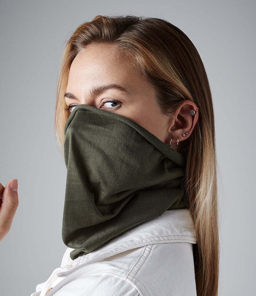 Woman wearing a military green neck gaiter up over her nose and mouth as a face covering