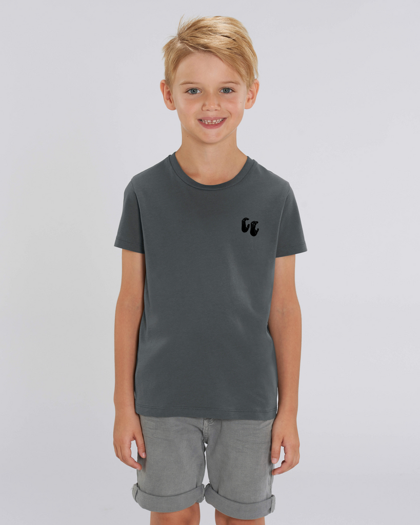 A boy wearing a kids organic cotton t-shirt in anthracite grey, with a printed black chest logo