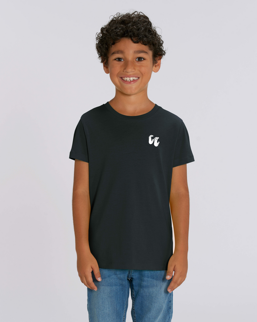 A boy wearing a kids organic cotton t-shirt in black, with a printed white chest logo