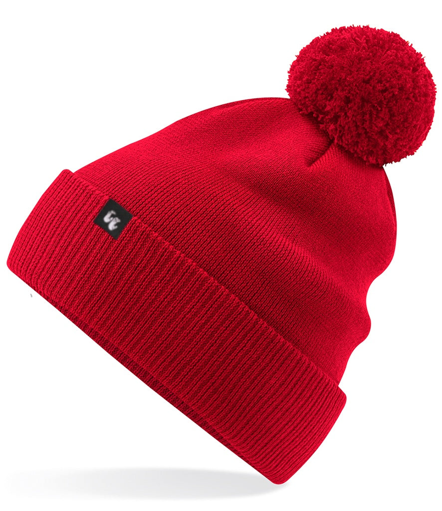 A classic, bright red bobble hat beanie with pom pom made from organic cotton