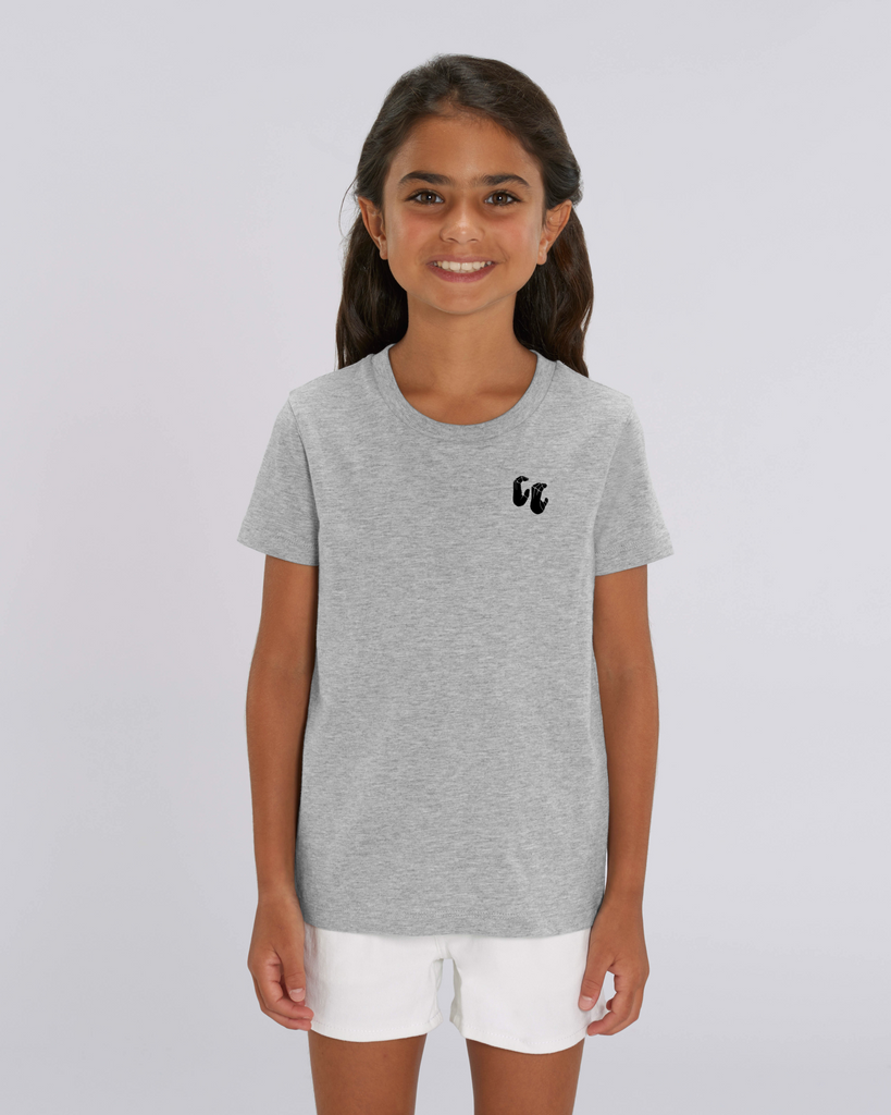 A girl wearing a kids organic cotton t-shirt in heather grey, with a printed black left chest logo
