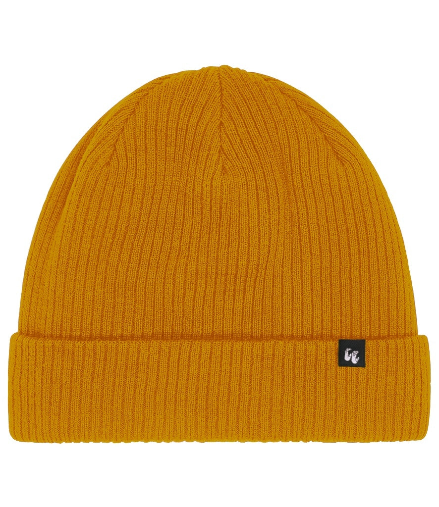 Front view of a mustard yellow organic cotton beanie hat with black fabric tag stitched to the cuff