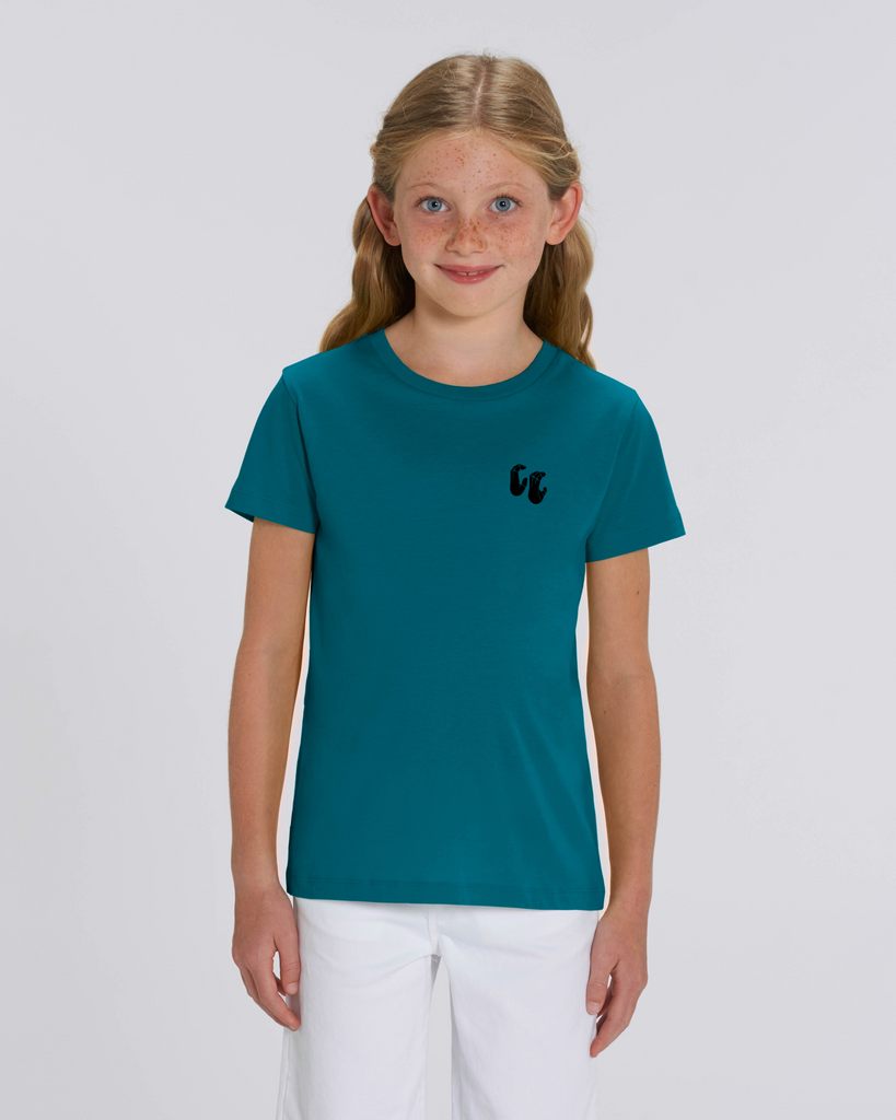 A young blonde girl wearing an organic cotton tshirt in ocean blue, with a printed black left chest logo